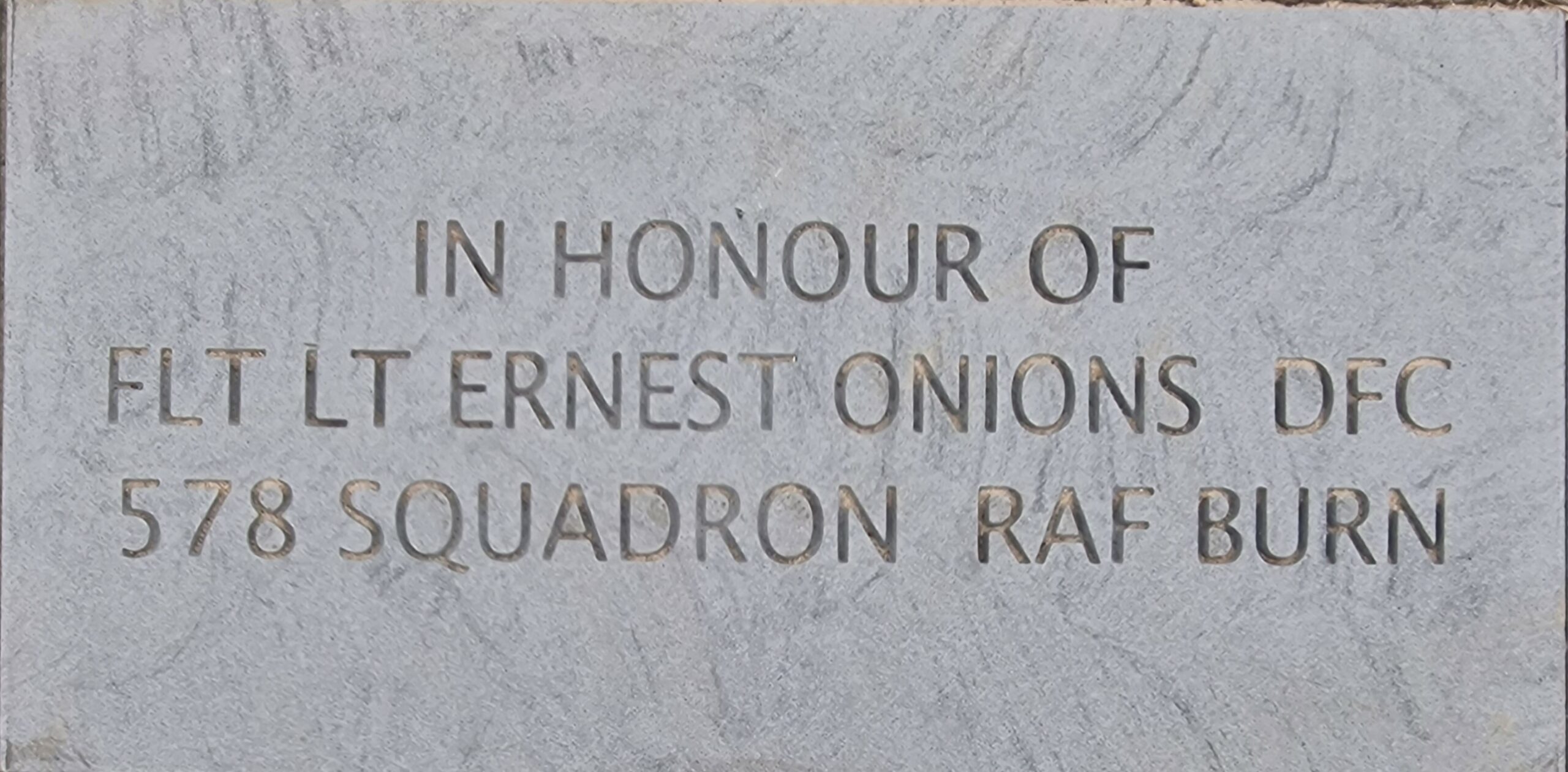 Colour photo of a stone laid in memory of Flt Lt Ernest Onions