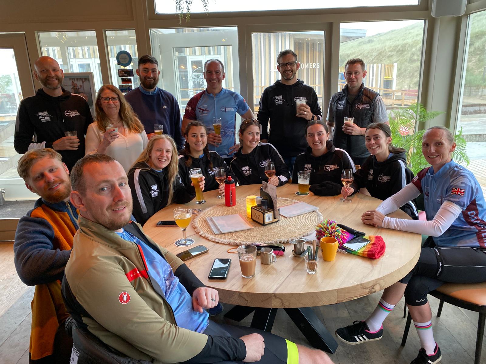 The Final Stretch -Group of 13 people gathered round a café table